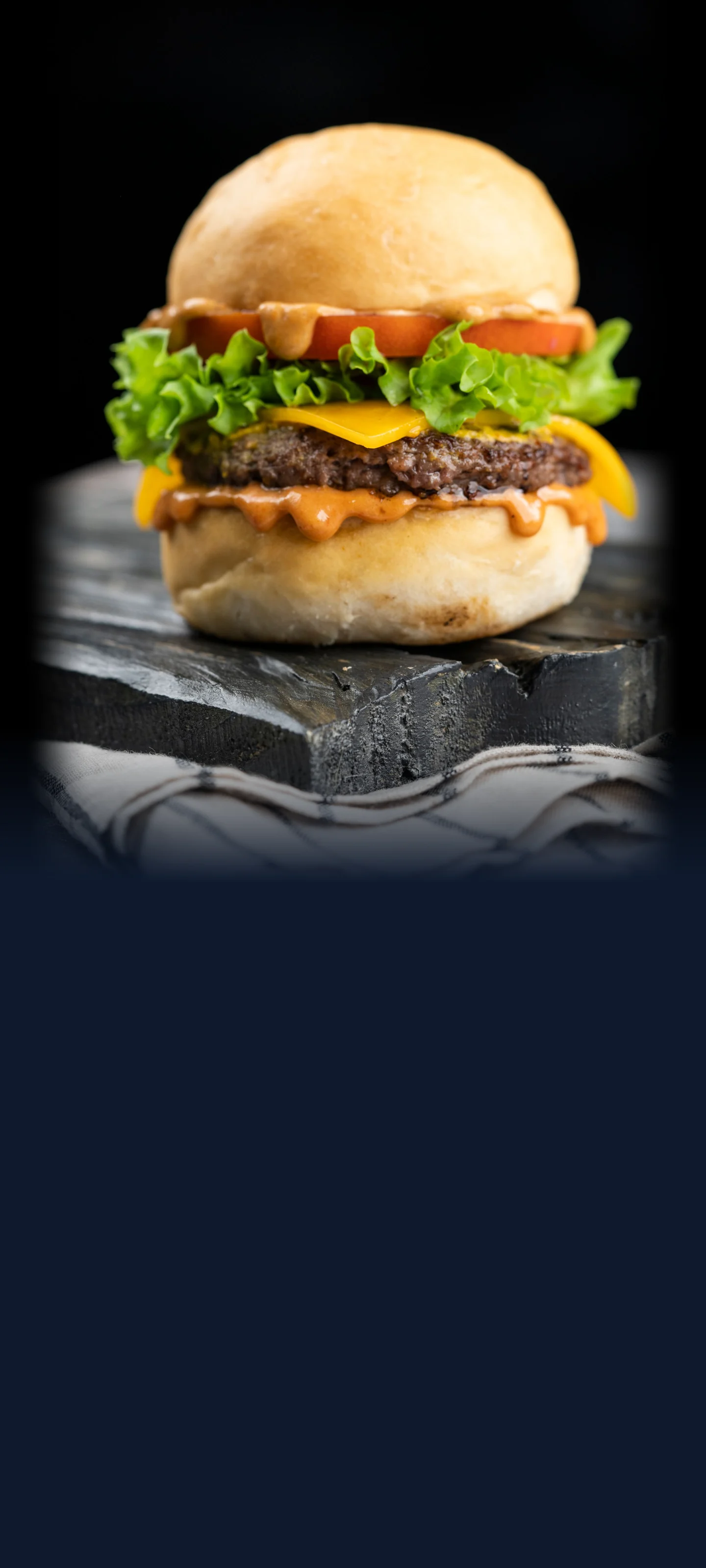 A juicy cheeseburger with cheese, lettuce and tomato